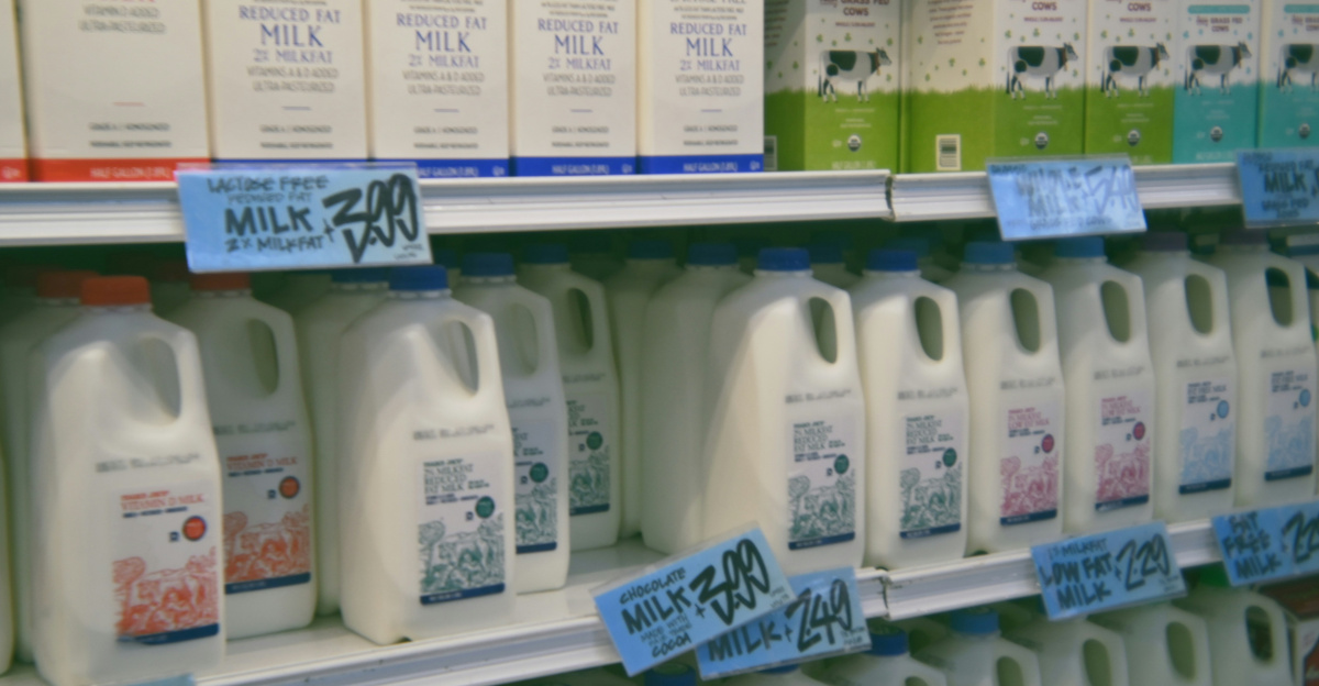A store shelf filled with lots of milk
