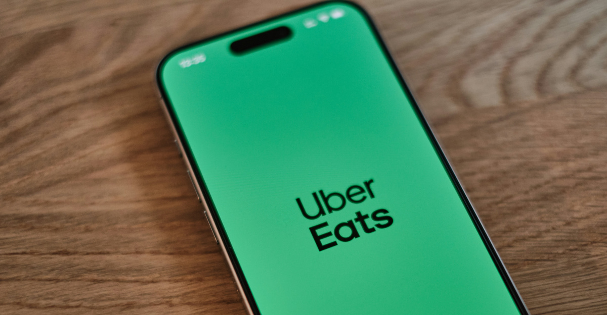 A green iPhone sitting on top of a wooden table