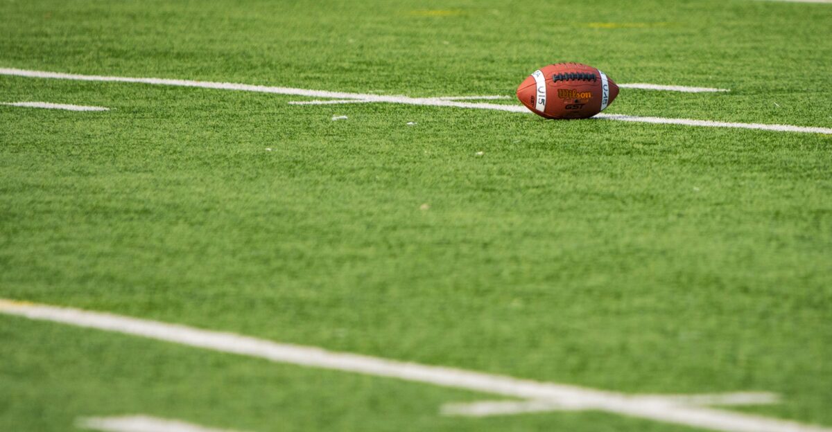A football laying on a football field