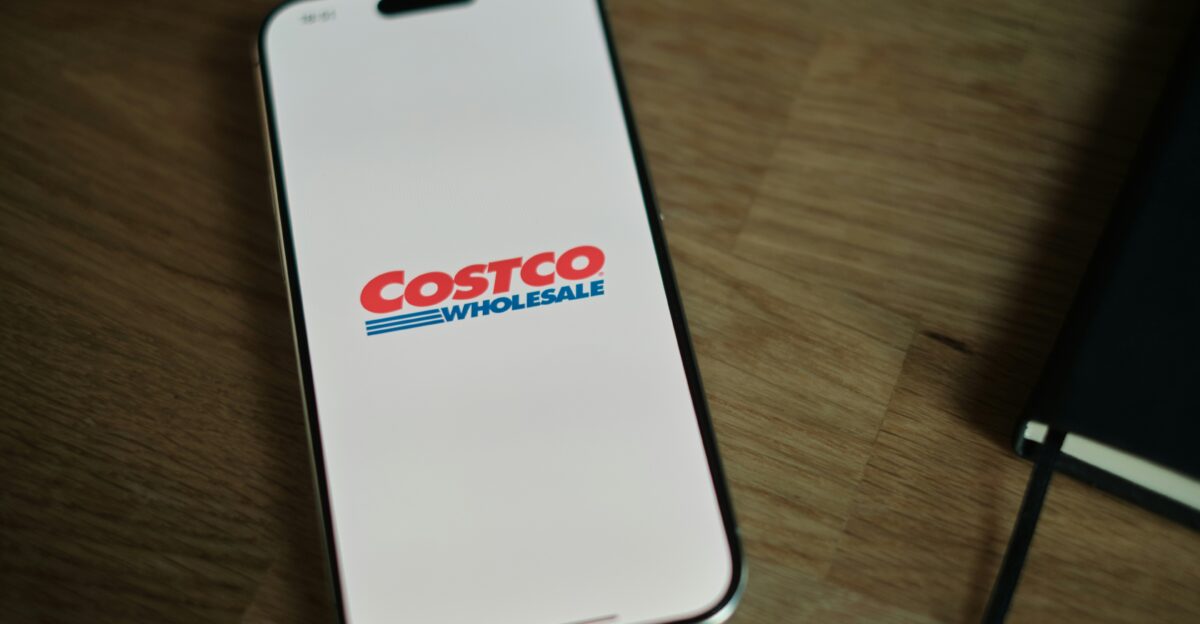 A white cell phone sitting on top of a wooden table