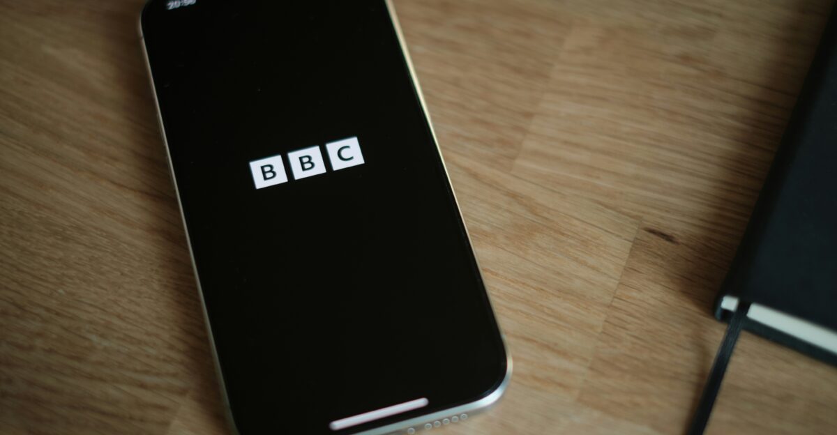 A cell phone sitting on top of a wooden table