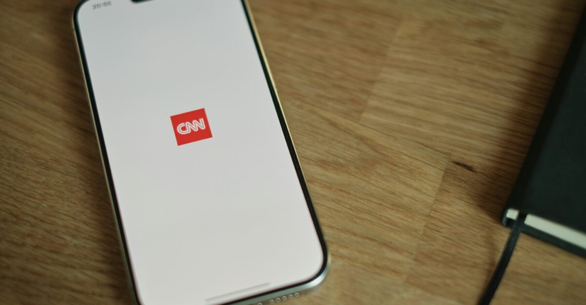 A cell phone sitting on top of a wooden table