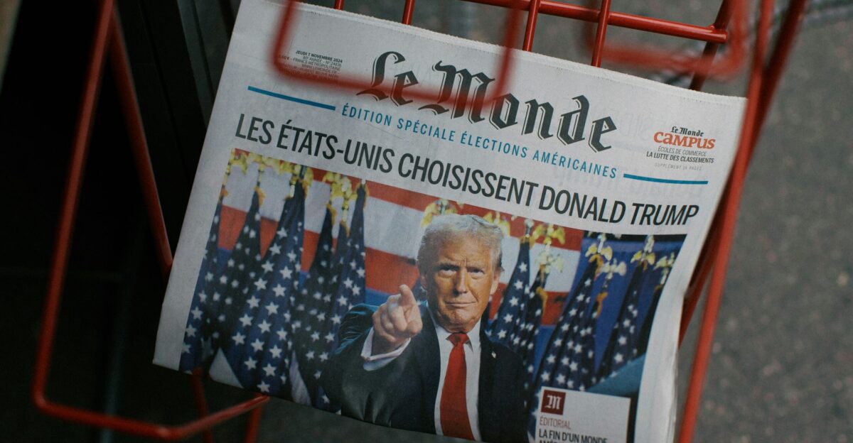 A newspaper sitting in a red shopping cart