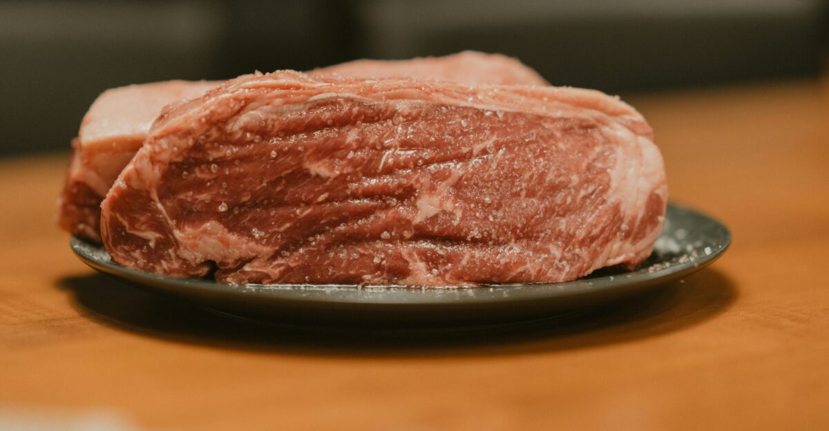 A piece of meat on a plate on a table