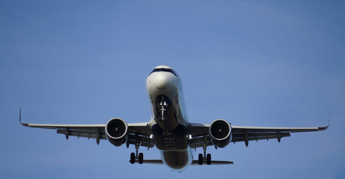 A large jetliner flying through a blue sky