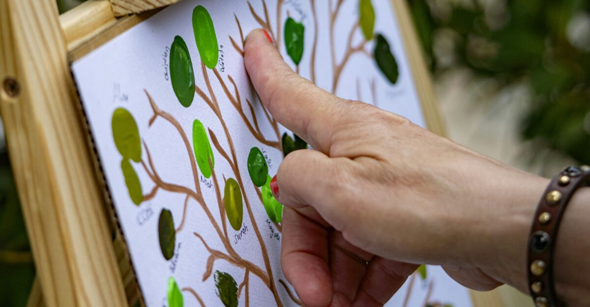 A person is painting a tree on a canvas