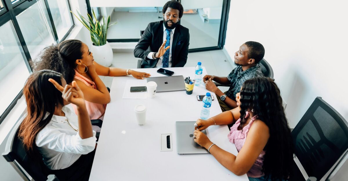 A group of people sitting around a white table
