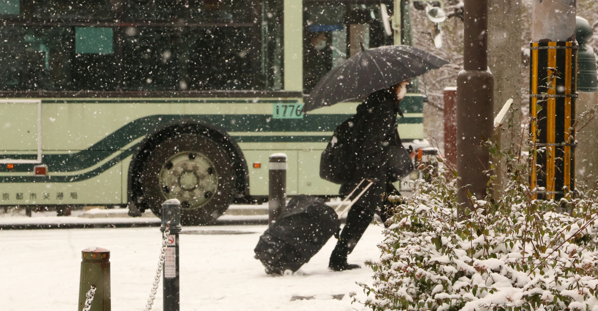 A bus driving down a snow covered street