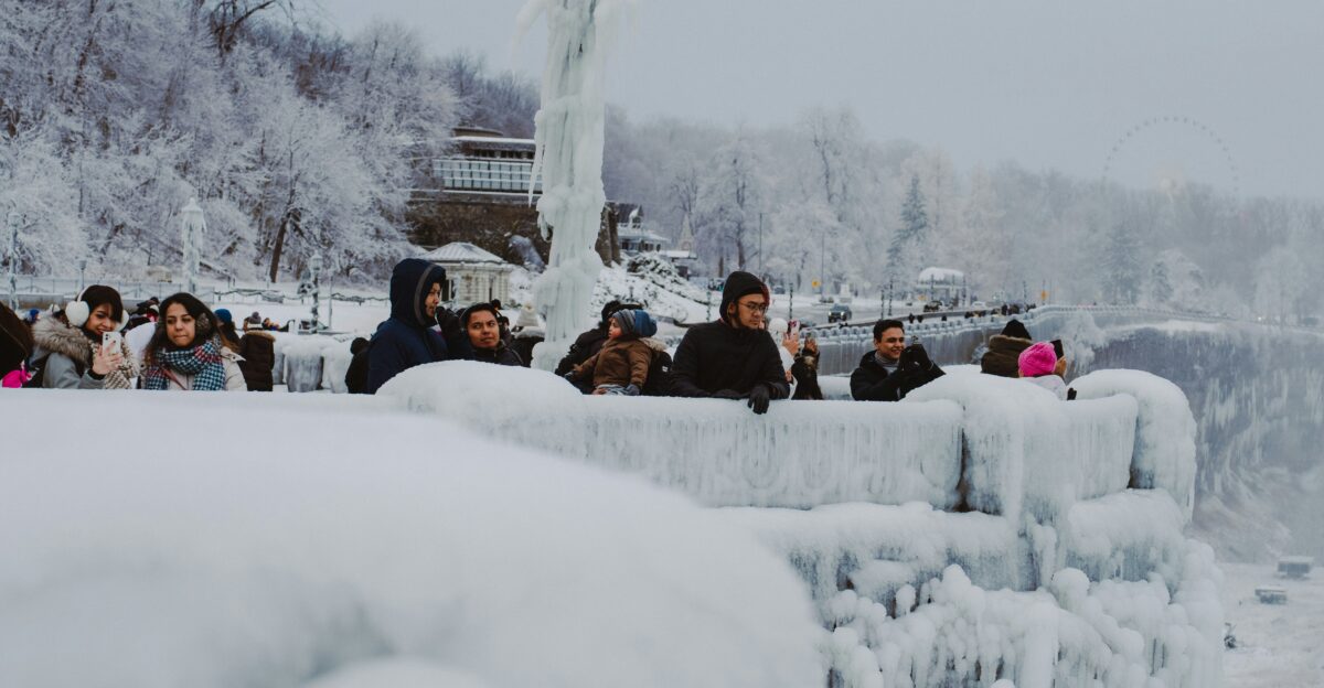 People are viewing a snowy waterfall