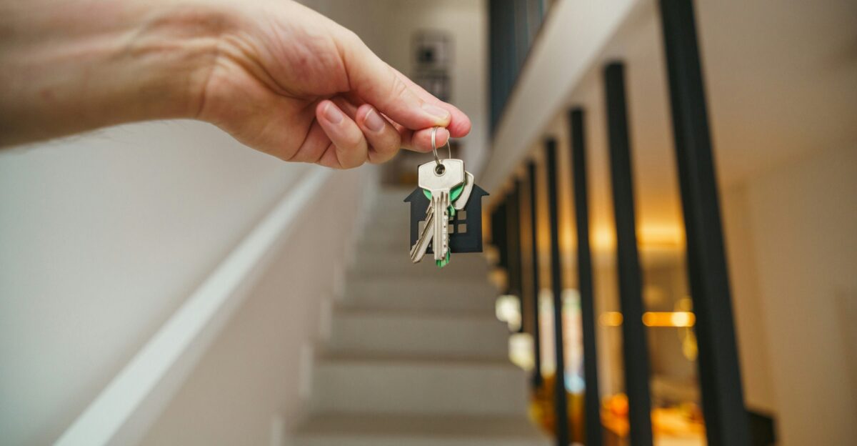 Here s a possible caption keys being held in front of a staircase