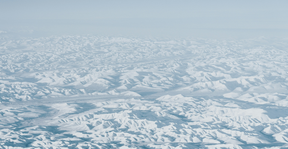 Snow-covered mountains stretch toward the horizon.