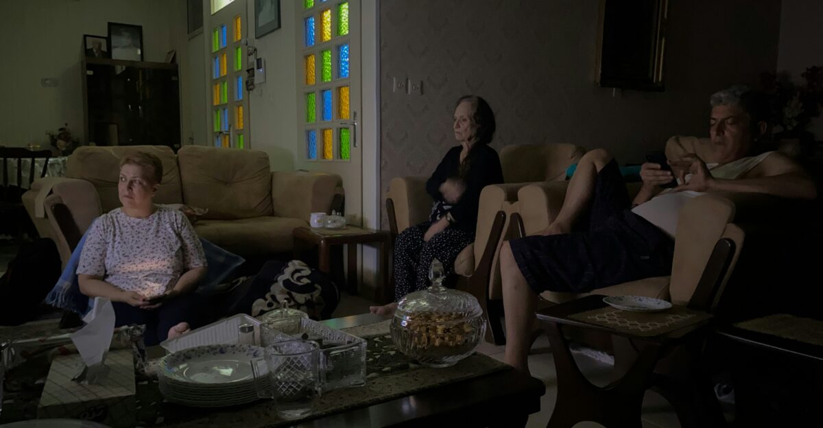People relax in a dimly lit living room