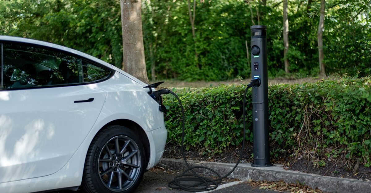 White electric car plugged in at a charging station