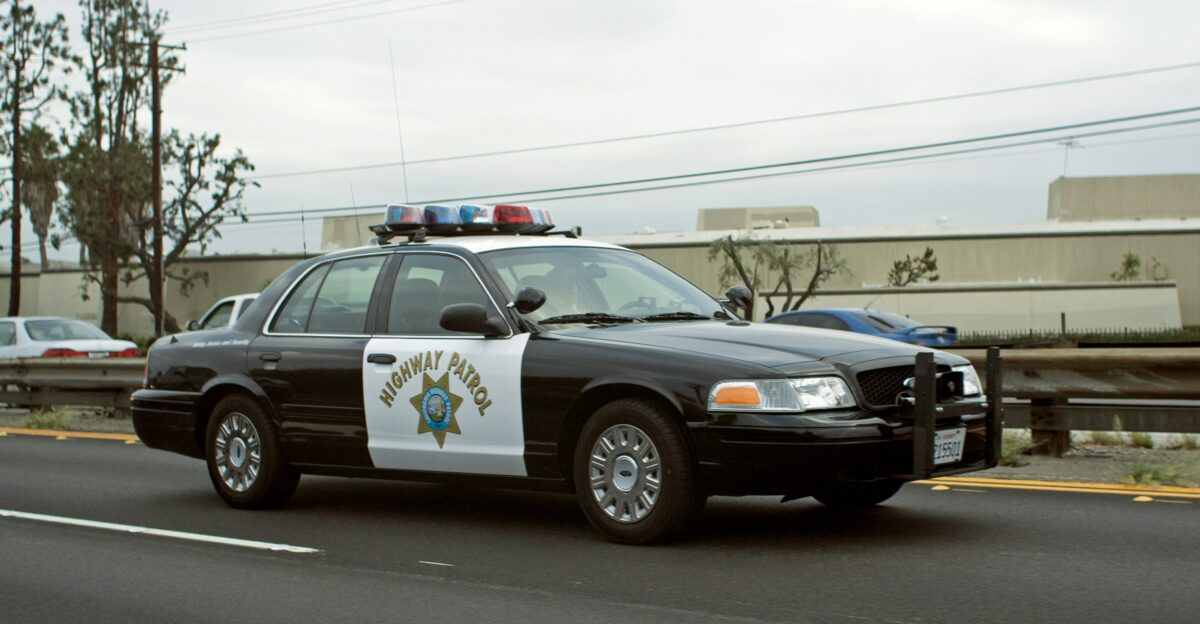A california highway patrol car drives down the road