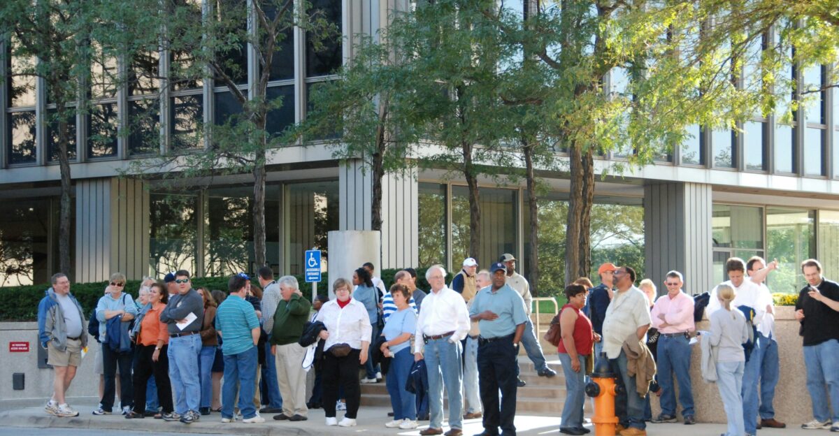 A crowd of people stands outside a building