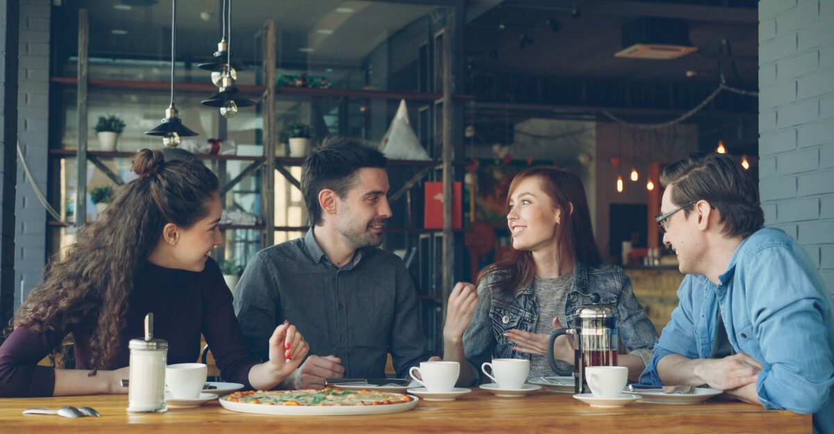 Friends are chatting and having coffee at a cafe