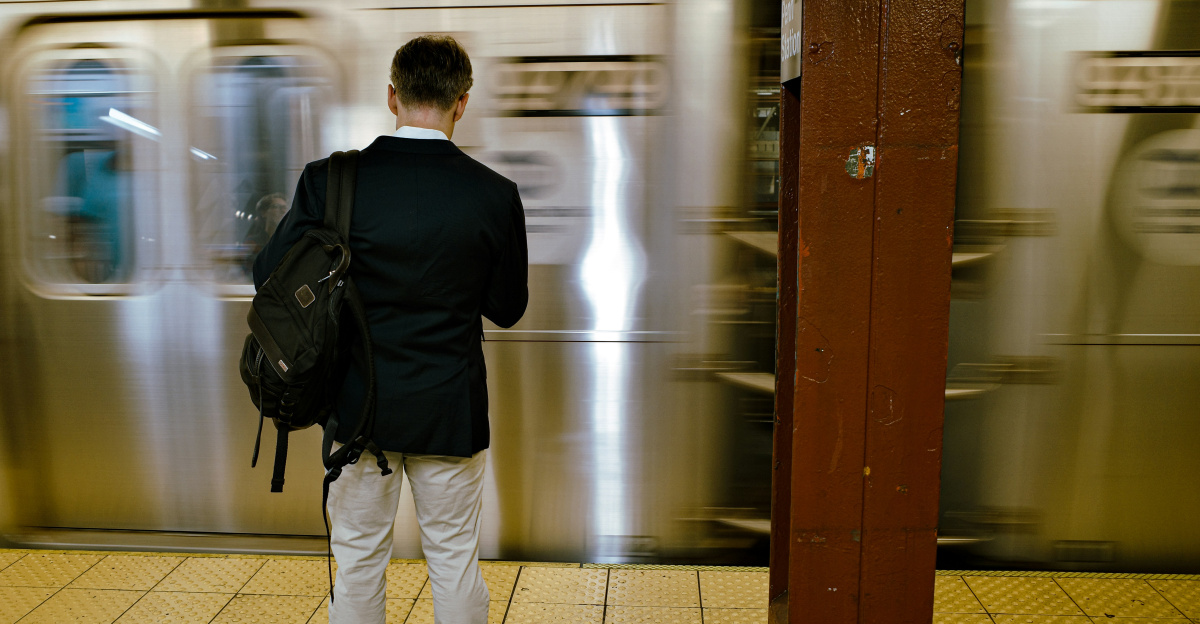A man waits for a train at the subway.