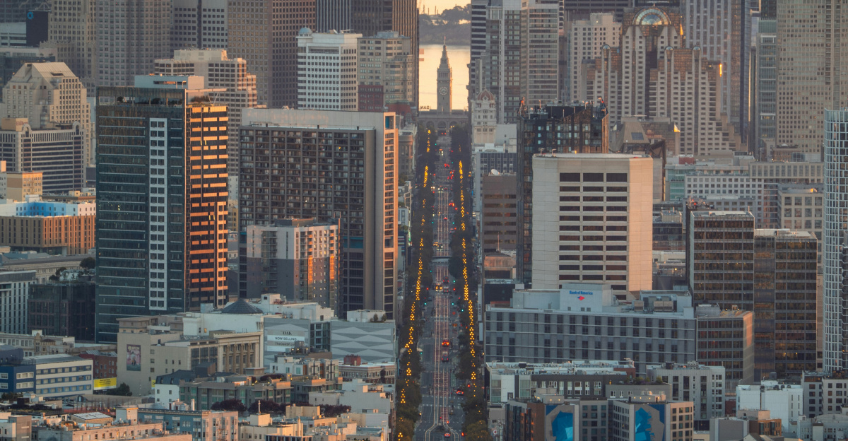 Cityscape view of buildings and a long road.