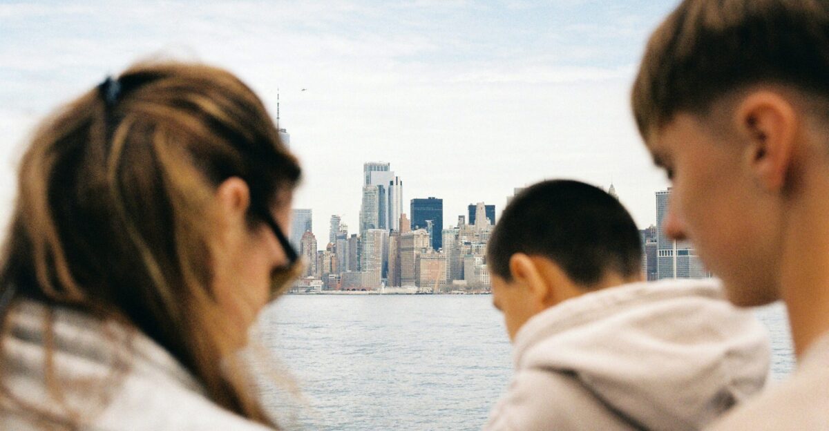 People gaze at a city skyline across the water