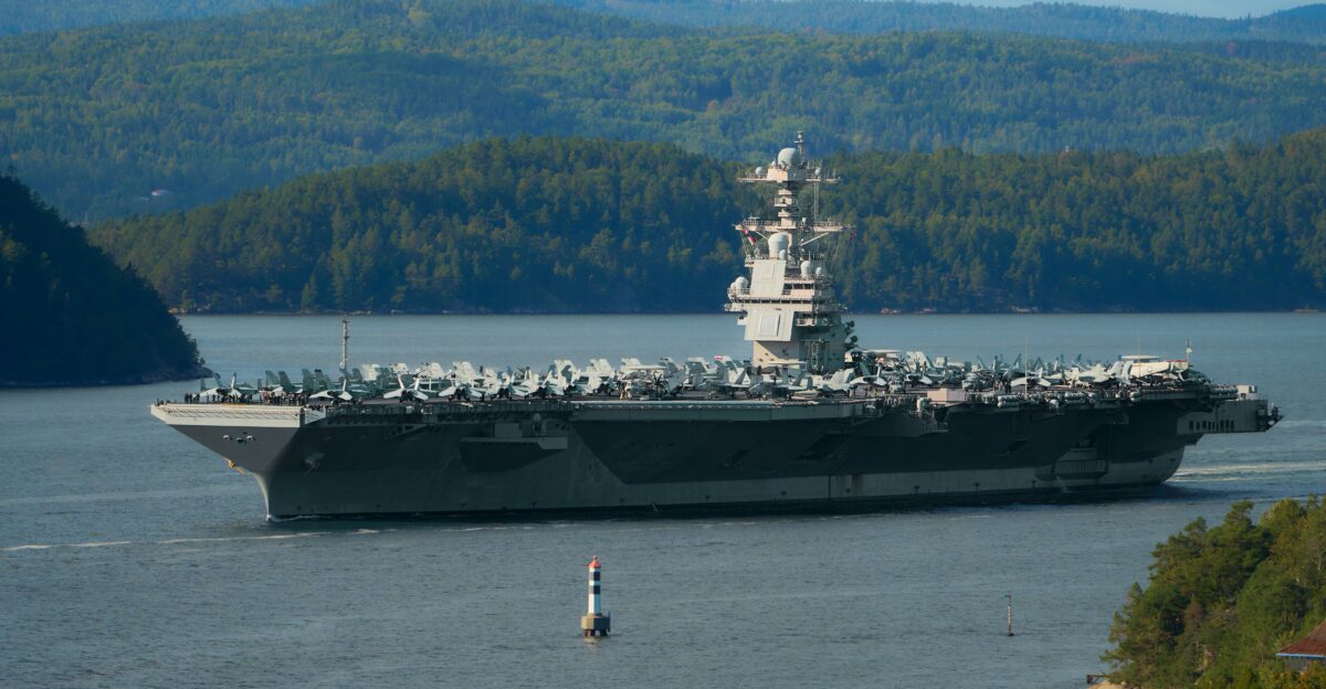 Aircraft carrier sailing on a calm body of water