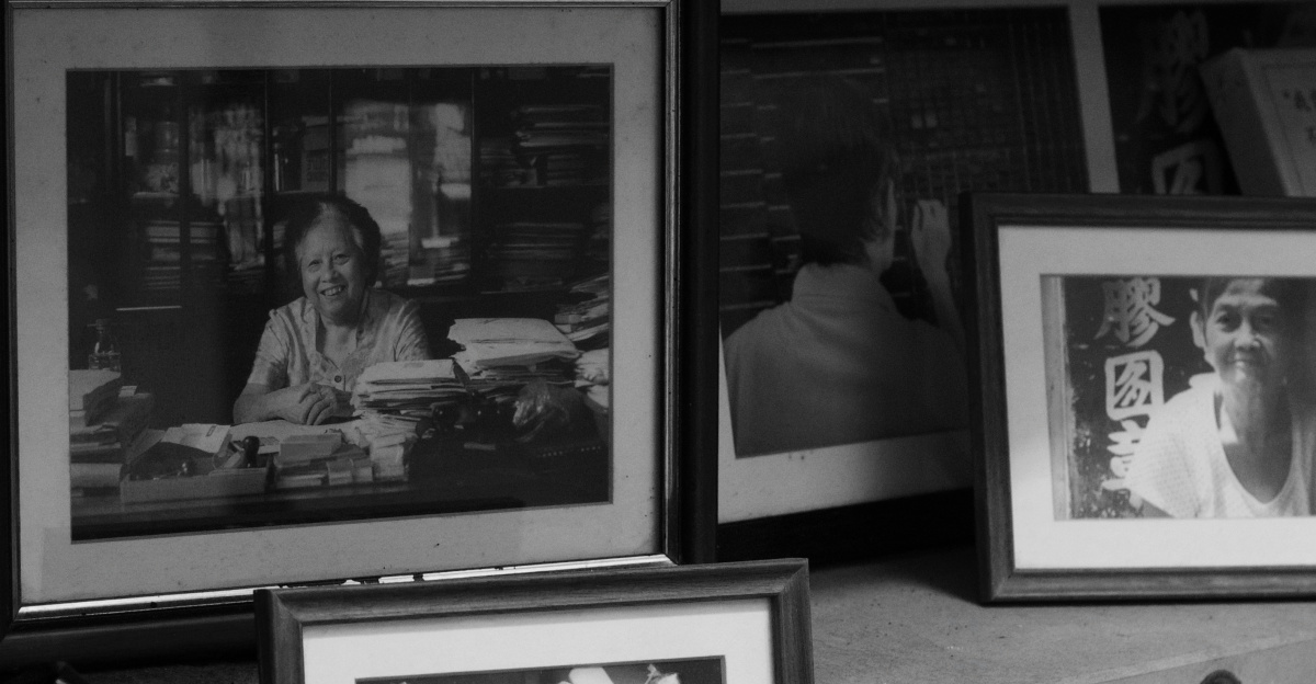 Framed black and white portraits on a shelf.