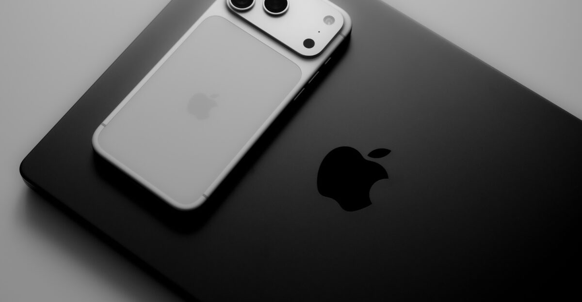 Silver smartphone resting on a black laptop