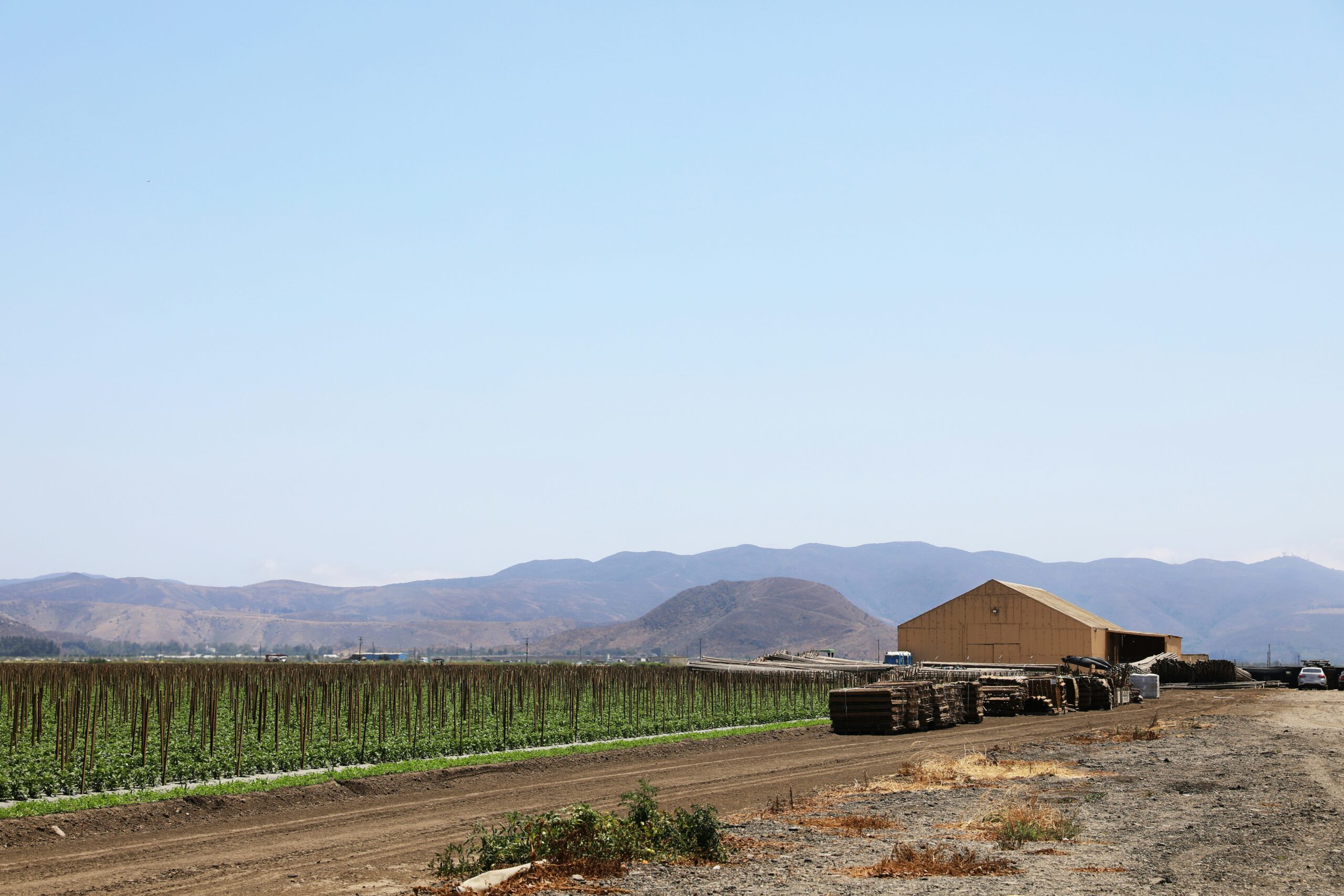 Farm fields with barn and mountains in background