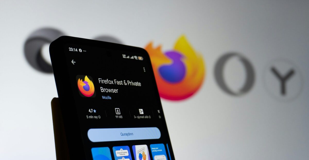 Smartphone displaying firefox browser with company logo in background