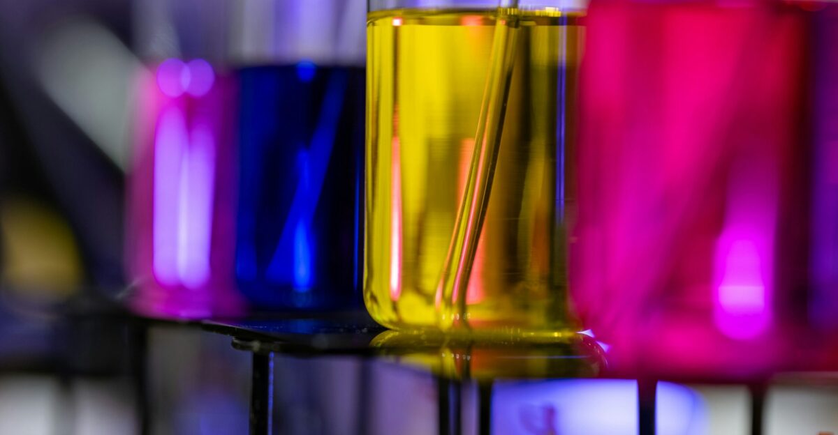 Colorful liquids in laboratory beakers on rack
