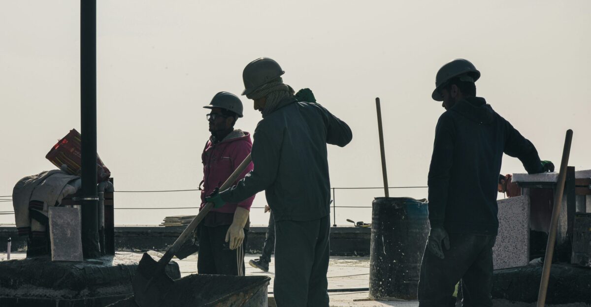 Construction workers in hard hats on a sunny day