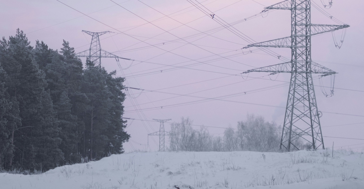 Power lines stretch across a snowy winter landscape.