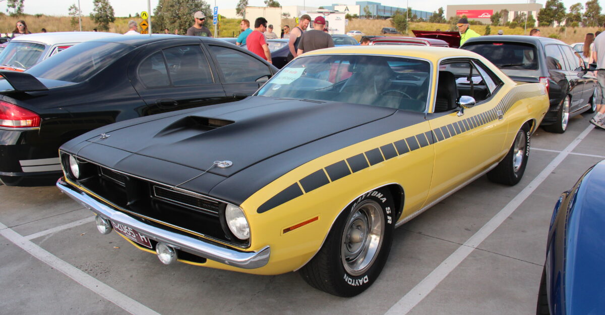 Top Banana Barracudas were built from 1964-74 The 2nd generation the 1970-1974 E-body Barracuda no longer Valiant-based was available as a coupe and a convertible both of which were very different from the previous models Sharing this platform was also the Dodge Challenger however no sheet metal interchanged between the two cars There was a base Barracuda the Gran Coupe was the luxury model and the performance car was called the Cuda available with 383 Magnum 440ci 4-barrel Super Commando the 440ci 6-barrel Super Commando Six Pak and the 426ci Hemi The AAR Cuda was the street version of what was raced in the Trans Am Series they against the likes of the TA Challenger Z28 Camaro and Boss 302 Mustang Engine was a 320 bhp 340 cu in V8 3 2 barrel carbs it had a matte-black fiberglass hood it got either a TorqueFlite automatic or pistol-grip Hurst-shifted four-speed transmission Rallye suspension chrome tipped megaphone outlets in front of the rear wheels Thick dual side stripes bold ID graphics and a fiberglass ducktail rear spoiler