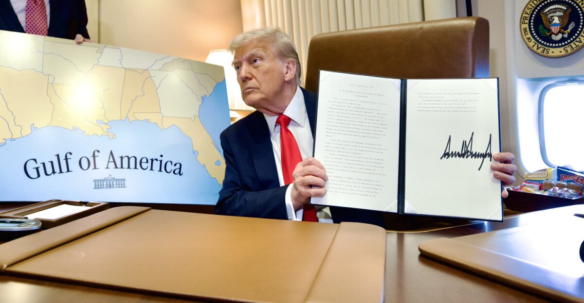 President Donald Trump on Air Force One poses next to a map of the Gulf of America during a flight to New Orleans on February 9 2025