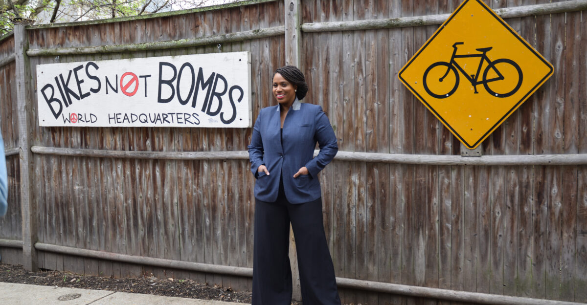 MA-07 representative Ayanna Pressley poses outside the Bikes Not Bombs headquarters in Jamaica Plain at its reopening ceremony after renovations