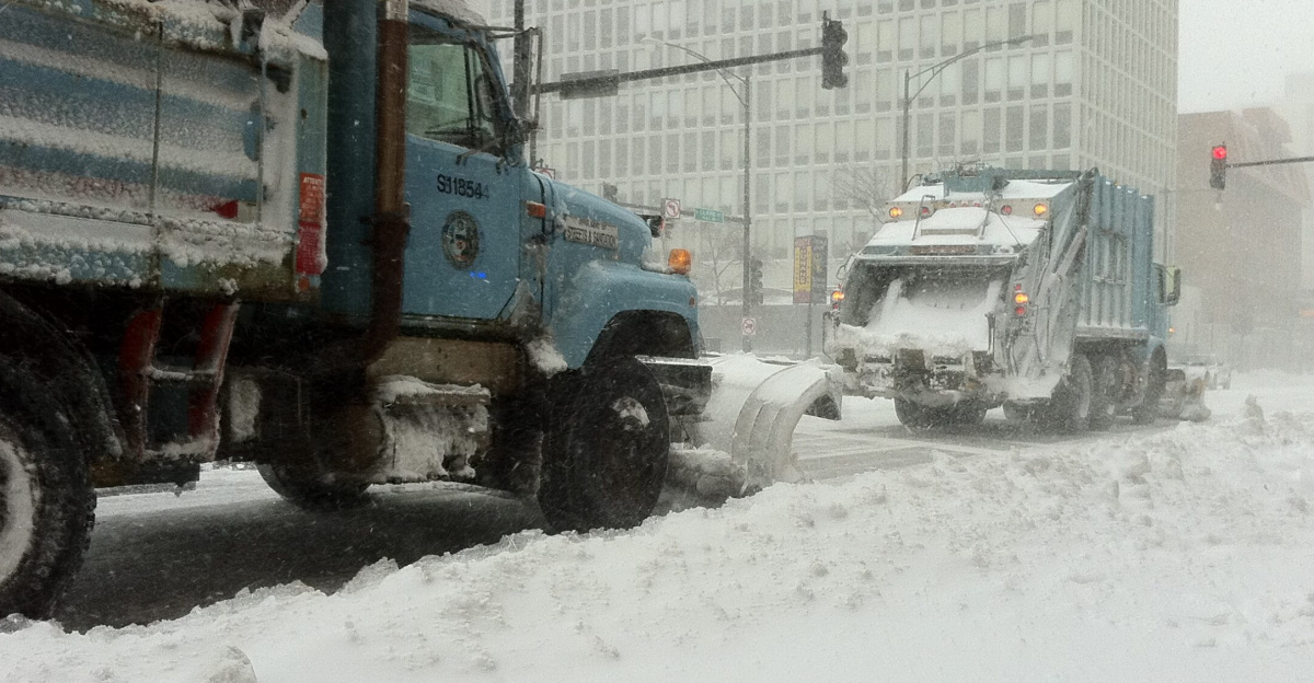 Retrofitted garbage trucks with snowplows shoveling snow on Clark and Fullerton during the Chicago storm of February 2, 2011