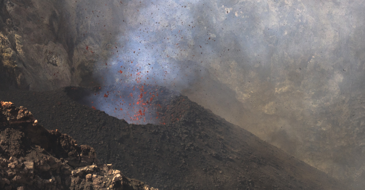 <p>Mount Etna is Europe's most active volcano, and rises more than 3km above the East coast of Sicily. During a research trip to the volcano's summit, in July 2012, I captured this image of a violent "strombolian" eruption - where violent explosions within the volcano shake the ground, and shower blobs of fresh lava tens of meters into the air. A rare break in the thick clouds of volcanic gas, which make working on Etna's summit so challenging, revealed the true power of the eruption long enough for me to take this shot. 
</p><p><br>
</p>
Photo by Robin Wylie (UCL Earth Sciences)