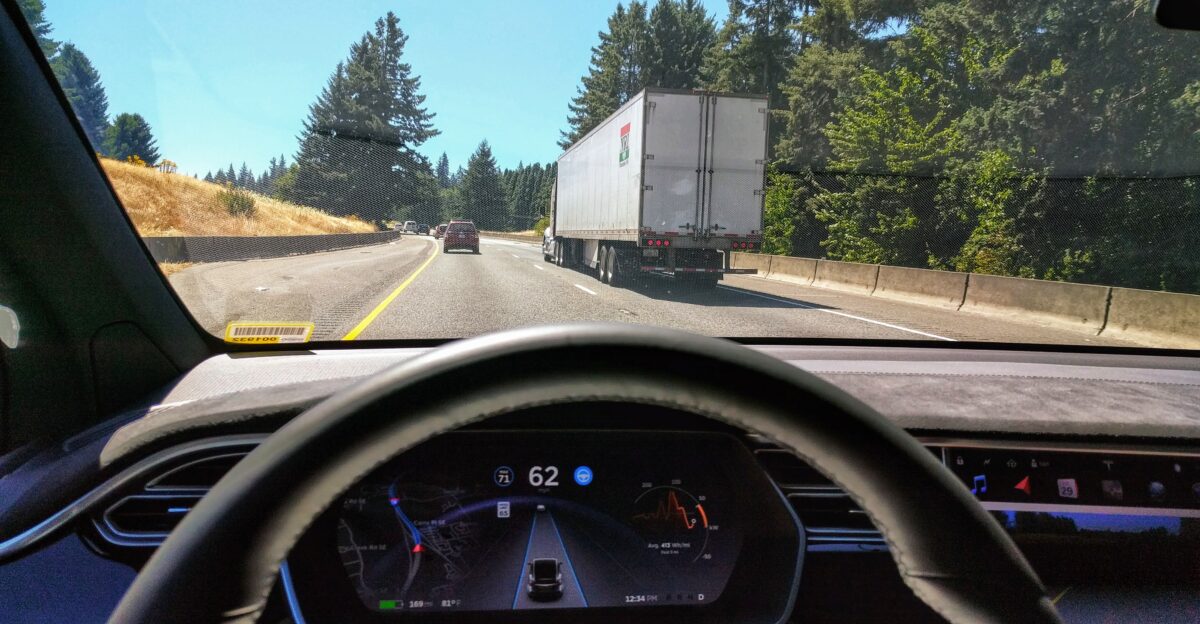 Driving in traffic with Tesla s autopilot controlling distance from the lead car and centering the vehicle in the lane Vehicle is a 2017 Model X 75D with dark interior