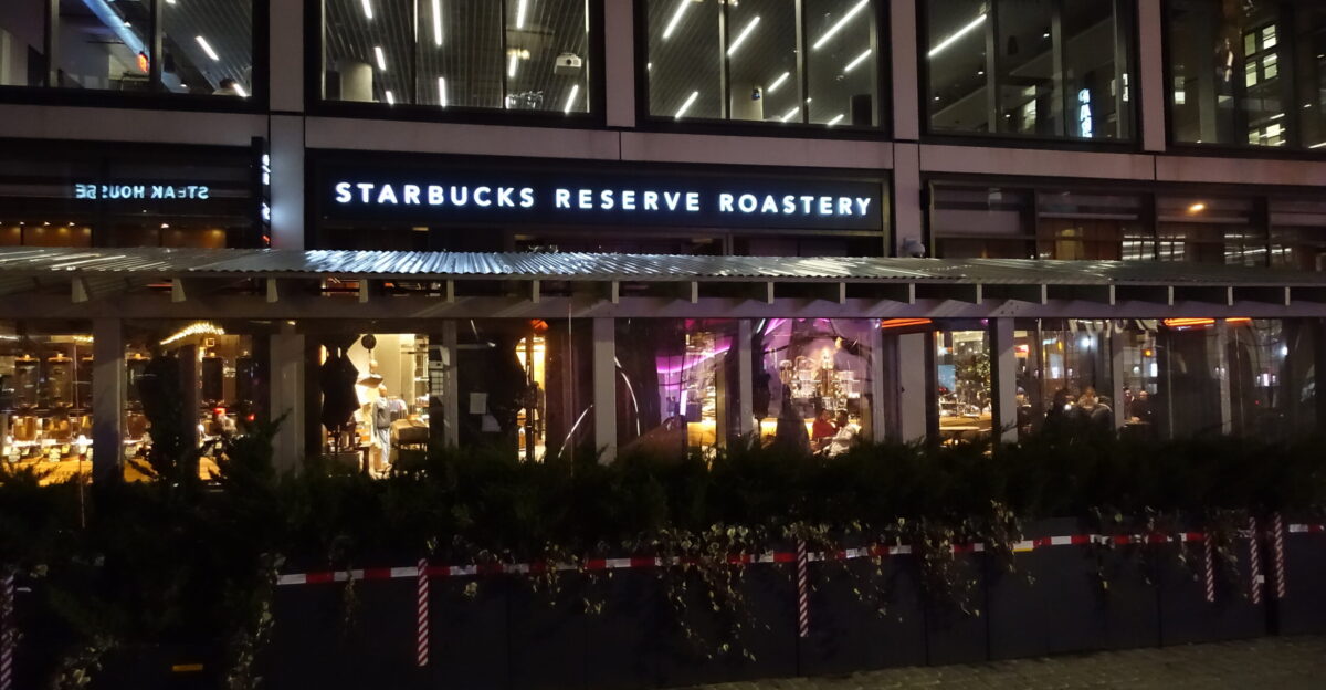 Outdoor tables for the Starbucks Reserve Roastery inside 61 Ninth Avenue at the north end of Chelsea Plaza part of Gansevoort Plaza at the southwest corner of 15th Street and 9th Avenue in the Meatpacking District Manhattan A standard Starbucks is located one block south