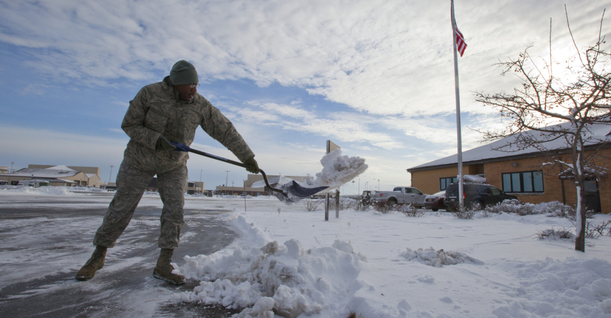 Staff Sgt. Gary Sill removes snow from the 108th Wing's headquarters' walkway at Joint Base McGuire-Dix-Lakehurst, N.J., Feb. 9, 2013. Airmen from the wing removed snow from winter storm Nemo during the early morning hours in preparation for February's weekend drill. (Air National Guard photo by Master Sgt. Mark C. Olsen/Released)
