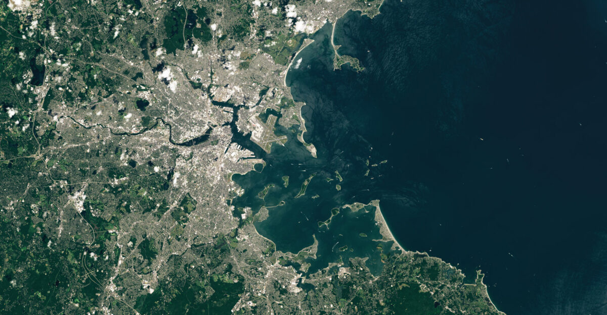 About 20 000 years ago during the peak of the Wisconsin Glaciation a massive ice sheet-over a mile thick in places-blanketed the land that now makes up Boston Harbor As this ice melted and eventually retreated it left piles of sediment and glacial debris in hundreds of elongated streamlined hills called drumlins Rising seas eventually flooded the features and turned many into islands creating the only partially submerged drumlin field in North America and one of only three in the world Several of these drumlin islands and peninsulas now make up the heart of the Boston Harbor Islands National and State Park which preserves many distinctive geological historical and natural resources The OLI Operational Land Imager on Landsat 8 captured this image of the harbor and its drumlin islands on July 19 2024 Of the park s 34 islands and peninsulas only four are accessible by car Deer Island Nut Island World s End and Webb Memorial Four others-Spectacle Island Georges Island Peddocks Island and Thompson Island-are served by seasonal ferries and several more are accessible by private boat The park is governed by the Boston Harbor Islands Partnership a federally legislated body made up of eleven agencies The islands support a range of ecosystems including salt marshes sandy beaches seagrass beds tidal pools mudflats grasslands and hardwood forests Lobsters crabs clams and fish such as striped bass bluefish and flounder inhabit the waters surrounding the islands Mussels and barnacles live in the intertidal zones and dozens of mammal bird reptile and amphibian species can be found on land Many of the islands have signs of human activity and history from campgrounds education centers and homes to former military infrastructure fields and health facilities Long Island for instance was once connected to Boston via a highway bridge and contains aging government buildings a performing arts center fire station chapel crematorium and other structures The bridge was closed in 2014 Peddocks Island one of the largest has privately owned cottages on its western end and the remains of a coastal fort Little Brewster Island hosts Boston Light the oldest continually operated light station in the United States While the lighthouse initially used tallow candles when it was built in 1716 kerosene was used starting in 1913 Today two 1 000-watt electric light bulbs produce a 1 8 million-candlepower white light Nearby Georges Island houses the remains of Fort Warren a bastion-style fort built in the shape of a pentagon between the 1830s and 1860s The fort was named after Revolutionary War hero Joseph Warren the man who sent Paul Revere on his famous Midnight Ride before the Battles of Lexington and Concord During the Civil War the fort was used as a prison for Confederate officers and government officials including Confederate Vice President Alexander Stephens The fort was mostly constructed of granite blocks sourced from nearby quarries in Quincy and Cape Ann Farther west lies Long Wharf a historically significant wharf at the base of today s State Street that once served as a hub for Boston s maritime trade When it first opened in the 1720s the wharf extended half a mile into the harbor allowing up to 50 vessels to dock at once Boston s ports have evolved over the decades and centuries with container cargo and cruise ships now arriving at terminals in South Boston and recreational boats docking at a marina on Long Wharf Editor s Note Explore satellite imagery of other national parks for National Park Week NASA Earth Observatory image by Wanmei Liang using Landsat data from the U S Geological Survey Story by Adam Voiland