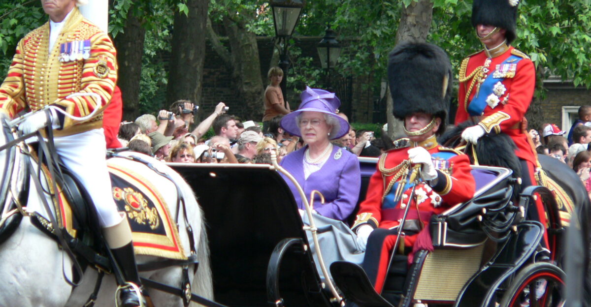 Her Majesty the Queen with the Duke of Edinburgh beside her and the Prince of Wales riding behind