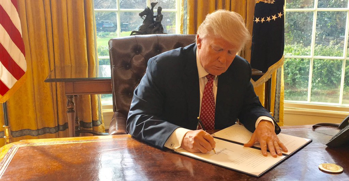 Trump signing Executive Order 13780