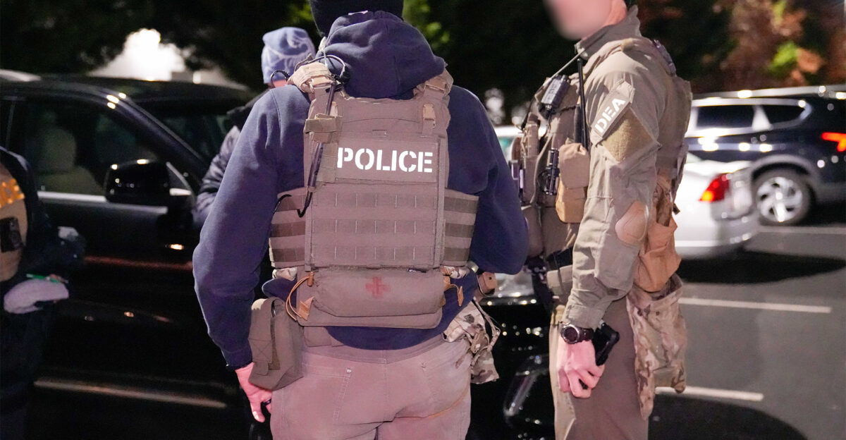 Federal law enforcement officials working with ICE and the DEA coordinate prior to beginning an enhanced immigration enforcement operation in the Washington D C area before dawn Feb 4