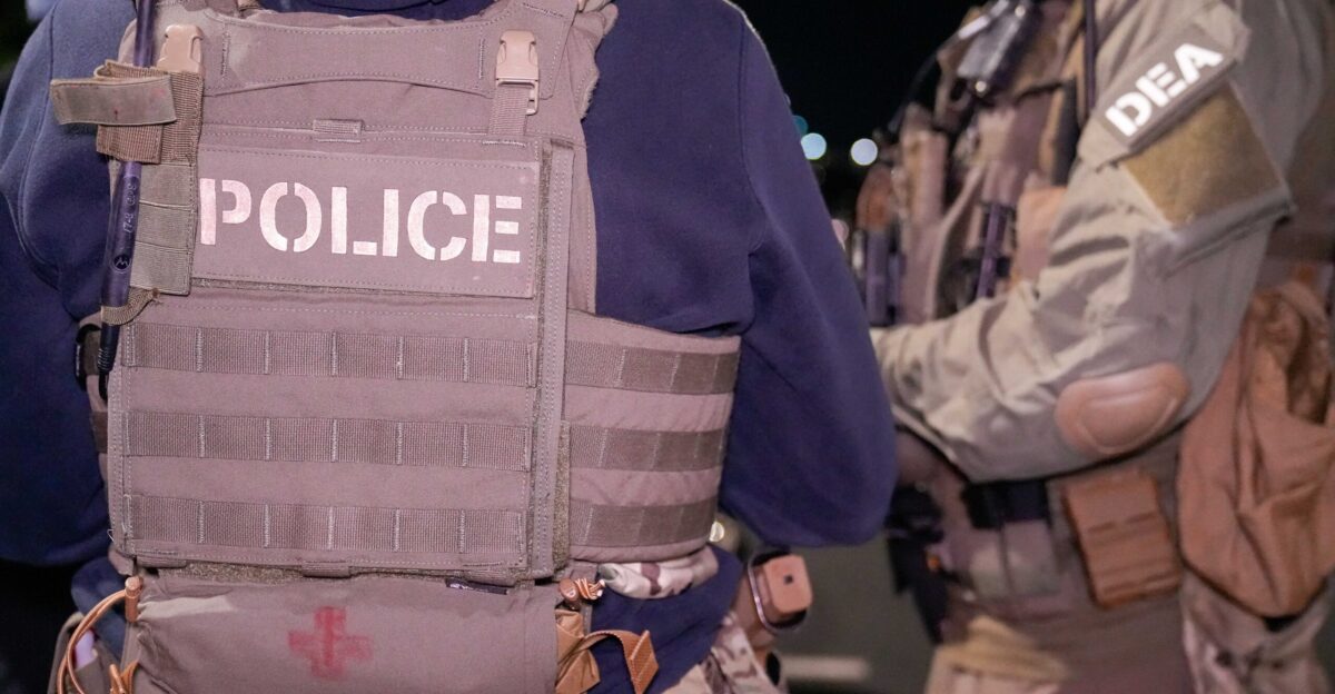 ICE and DEA law enforcement officials conduct a pre-dawn briefing prior to an enhanced immigration enforcement operation in a Washington D C suburb on the morning of Feb 4