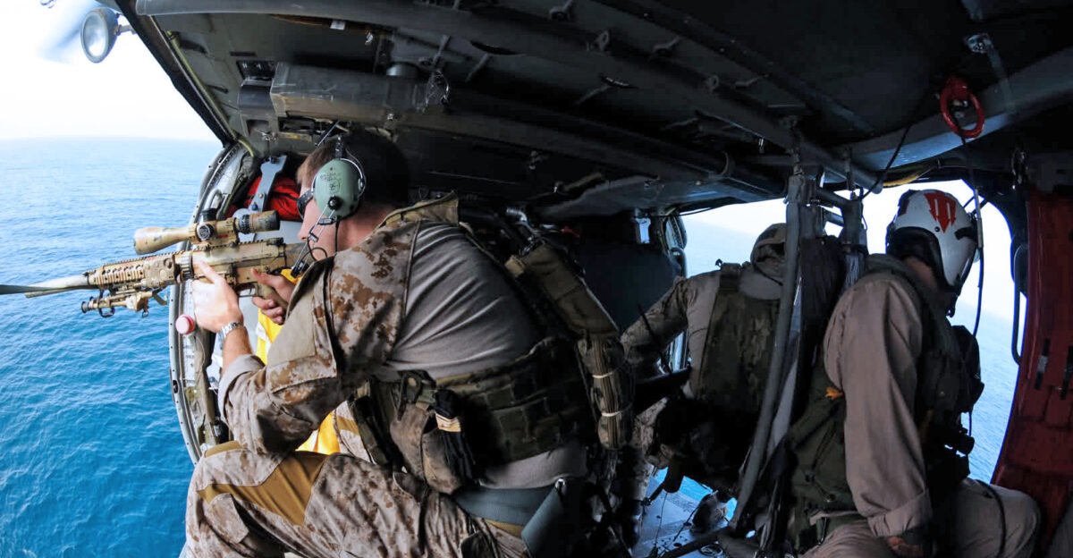 Navy Seal in a helicopter with a M110