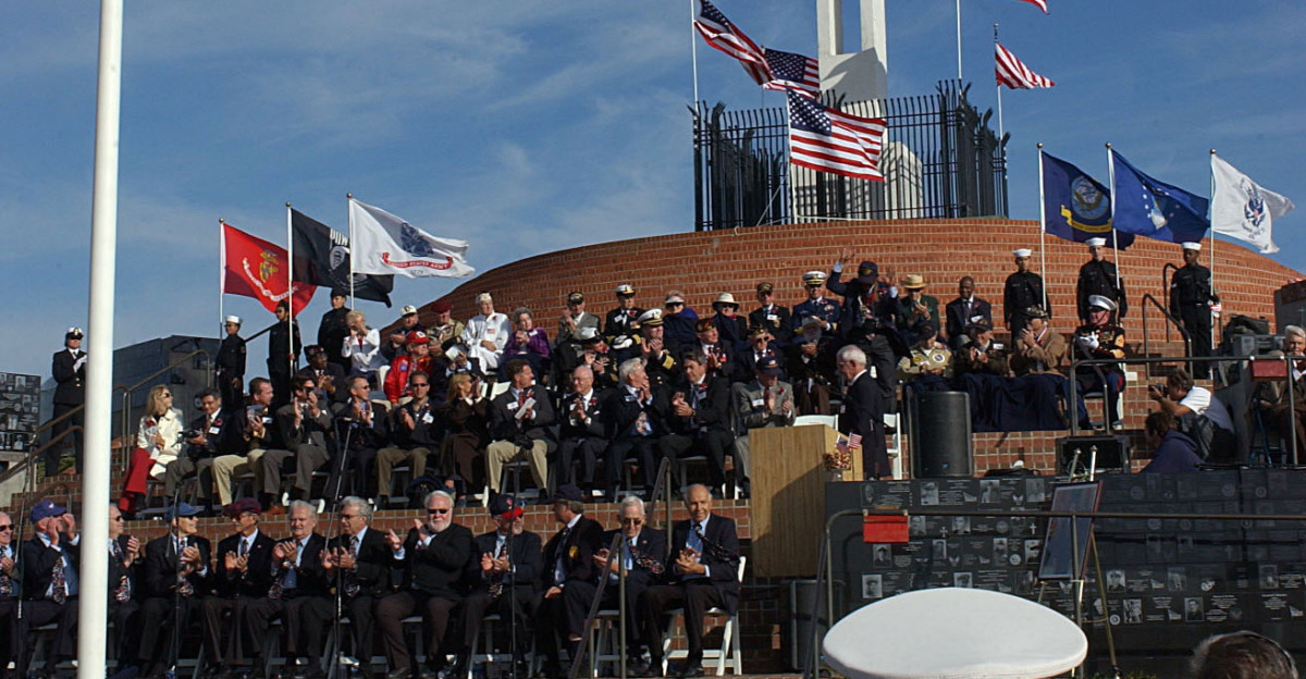 La Jolla Calif Nov 11 2004 - Veterans active duty military and civilians pay tribute to America s heroes during a ceremony held at Mt Soledad Veterans War Memorial in La Jolla California The Mt Soledad Veterans War Memorial is a unique memorial that honors veterans - living and deceased - from all wars and conflicts during the Nation s history U S Navy photo by Photographer s Mate Airman Kathleen Gorby RELEASED