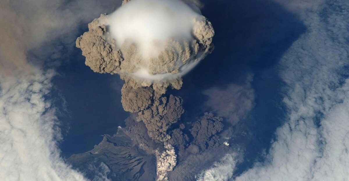 Stunning bird s eye view of a volcanic eruption with massive ash cloud and smoke plumes