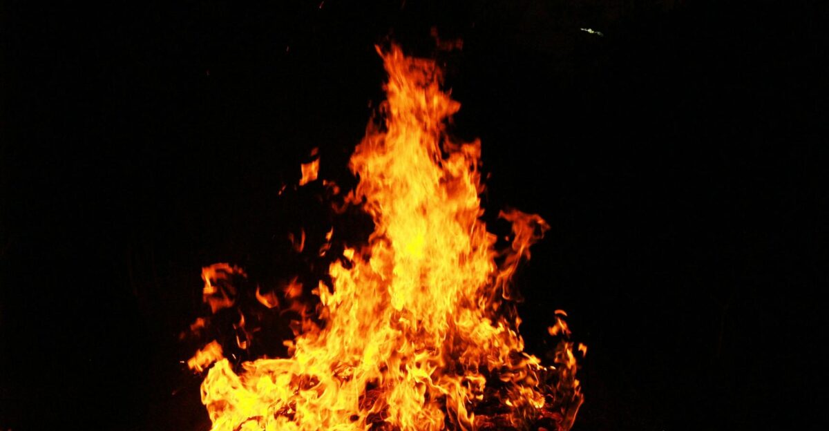 Dramatic image of a brightly burning bonfire against a dark night backdrop