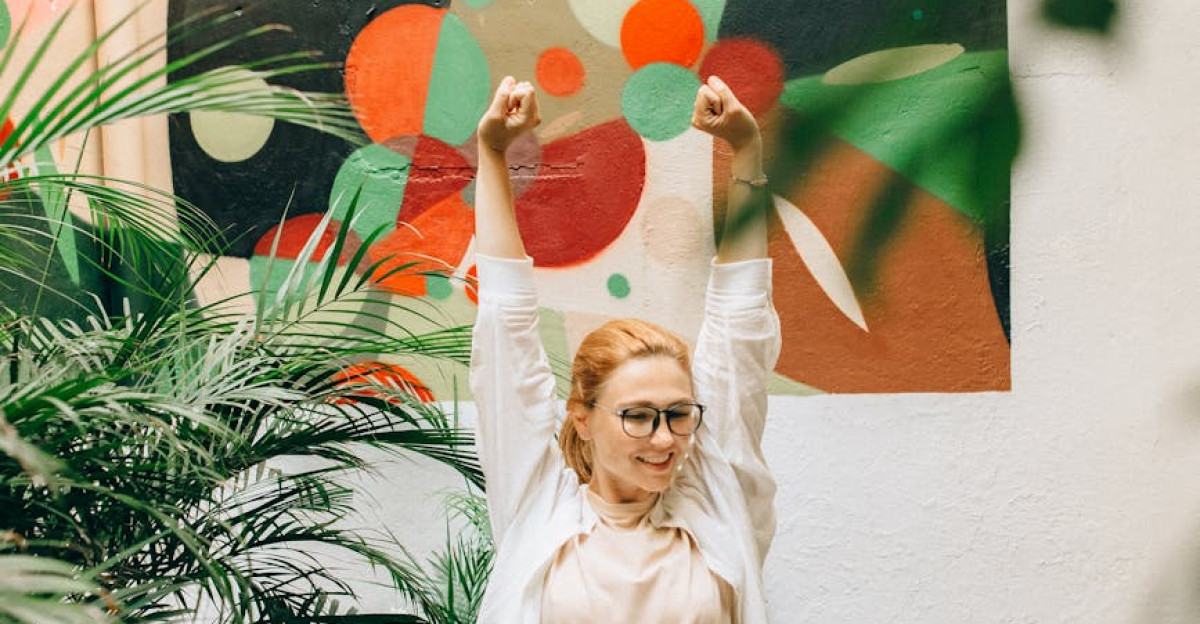 A joyful woman stretching at an outdoor workspace embracing creativity and nature