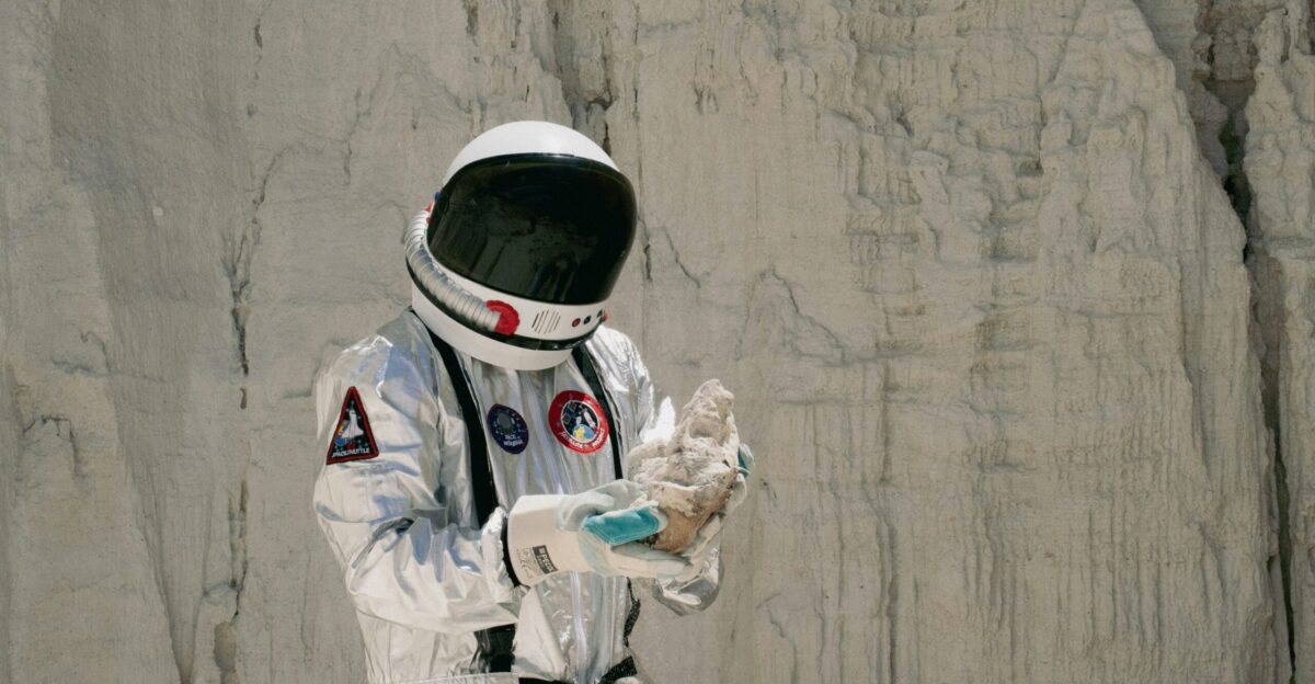 a man in a space suit holding something in his hands
